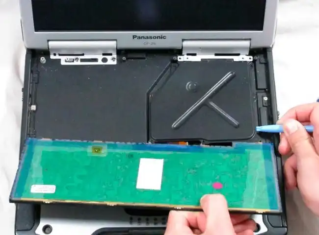 Pull the cover plate out. It will reveal the ribbon cable connections to the motherboard
