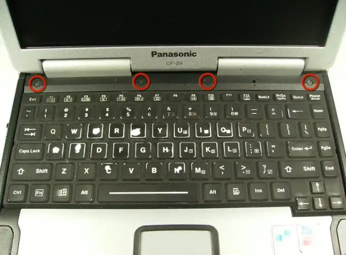 Remove the four screws above the keyboard
